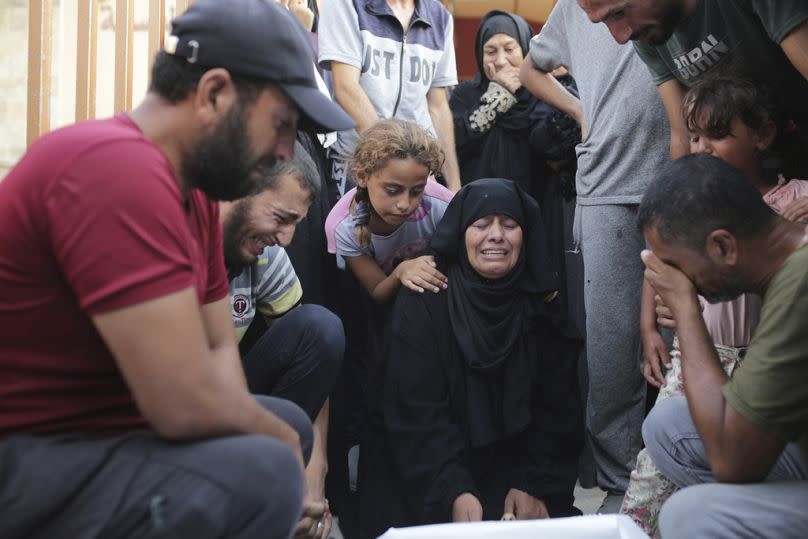 A Palestinian family mourns a loved one killed by Israeli bombardment , as they take a last look before their funeral in Khan Younis, southern Gaza Strip, Friday, June 21.