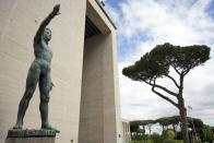 FILE - A bronze sculpture by Italo Griselli, known under the Fascist regime as "Saluto Fascista" (Fascist Salute) and after the war renamed Genio dello Sport (Genius of Sport), stands at the entrance of a fascist architecture building in the EUR neighborhood, in Rome, Monday, May 6, 2019. The Brothers of Italy party has won the most votes in Italy’s national election. The party has its roots in the post-World War II neo-fascist Italian Social Movement. Giorgia Meloni has taken Brothers of Italy from a fringe far-right group to Italy’s biggest party. (AP Photo/Andrew Medichini, File)