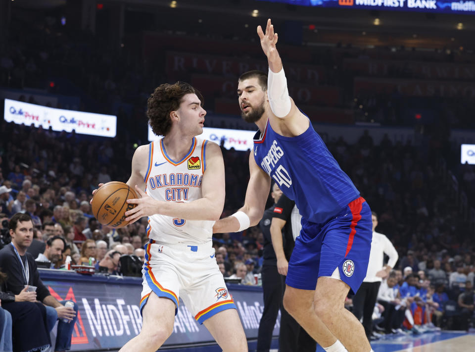 Feb 22, 2024; Oklahoma City, Oklahoma, USA; Oklahoma City Thunder guard Josh Giddey (3) is defended by LA Clippers center Ivica Zubac (40) as he moves the ball during the first quarter at Paycom Center. Mandatory Credit: Alonzo Adams-USA TODAY Sports