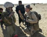 BOLDOC, AFGHANISTAN - NOVEMBER 23: (SPAIN OUT, FRANCE OUT, AFP OUT) Lance Corporal Riane Donoho, 21, US Marine with the FET (Female Engagement Team) 1st Battalion 8th Marines, Regimental Combat team II trades hats with an Afghan boy during a village medical outreach November 23, 2010 in Boldoc, in Helmand province , Afghanistan. There are 48 women presently working along the volatile front lines of the war in Afghanistan deployed as the second Female Engagement team participating in a more active role, gaining access where men can't. The women, many who volunteer for the 6.5 month deployment take a 10 week course at Camp Pendleton in California where they are trained for any possible situation, including learning Afghan customs and basic Pashtun language. (Photo by Paula Bronstein/Getty Images)