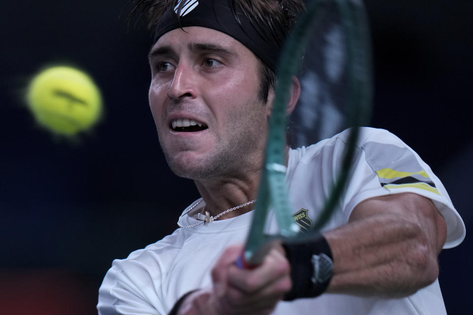 Tomas Martin Etcheverry of Argentina returns a backhand shot to Jannik Sinner of Italy during the men's singles match in the Shanghai Masters tennis tournament at Qizhong Forest Sports City Tennis Center in Shanghai, China, Sunday, Oct. 6, 2024. (AP Photo/Andy Wong)