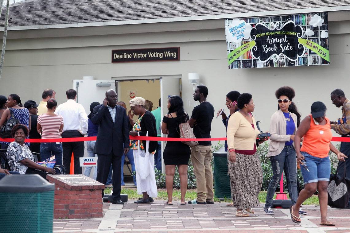 A group of people stand in line waiting to vote early outside the North Miami Public Library in this November 2016 file photo.