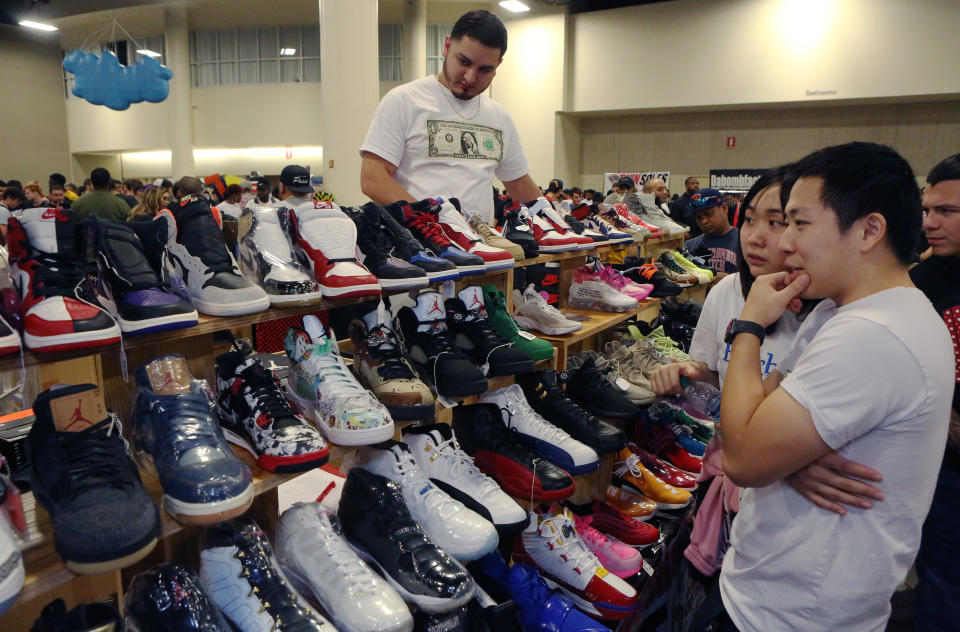 FT LAUDERDALE, FLORIDA - FEBRUARY 02: Shoppers inspect sneakers on sale by Texas Shoe Exchange during SneakerCon 2019 at Fort Lauderdale Convention Center on February 2, 2019 in Fort Lauderdale, Florida.  (Photo by Sean Drakes/Getty Images)