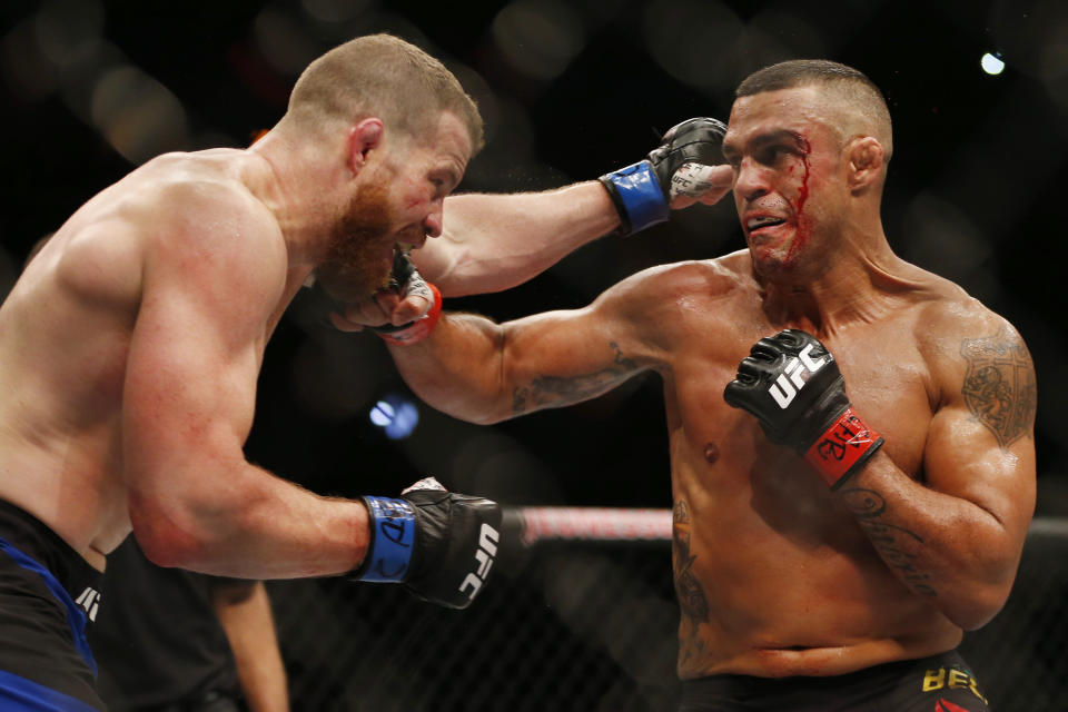 Vitor Belfort, right, of Brazil, trades blows with Nate Marquardt, of the United States, during their UFC middleweight mixed martial arts bout in Rio de Janeiro, Brazil, early Sunday, June 4, 2017. (AP Photo/Leo Correa)
