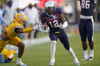 Jackson State's Travis Hunter (12) holds on to a pass as Southern University defensive back Jordan Carter (7) reaches out in a tackle attempt during the first half of the Southwestern Athletic Conference championship NCAA college football game Saturday, Dec. 3, 2022, in Jackson, Miss. (AP Photo/Rogelio V. Solis)