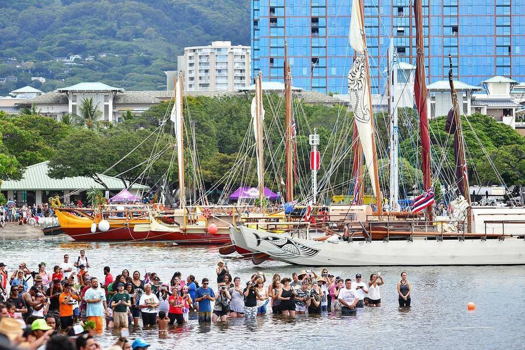 A traditional Polynesian canoe just returned from a global voyage, guided by a female navigator and captain