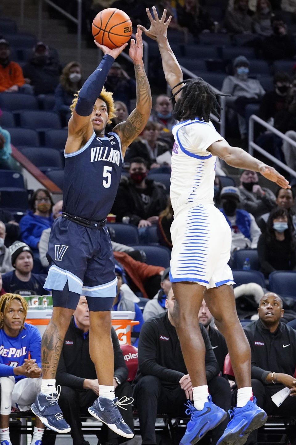 Villanova guard Justin Moore, left, shoots against DePaul guard Javon Freeman-Liberty during the first half of an NCAA college basketball game in Chicago, Saturday, Jan. 8, 2022. (AP Photo/Nam Y. Huh)