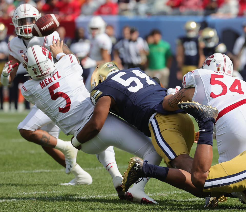 CHICAGO, ILLINOIS - SEPTEMBER 25: Graham Mertz #5 of the Wisconsin Badgers tries to get off a pass as he's hit by Blake Fisher #54 of the Notre Dame Fighting Irish at Soldier Field on September 25, 2021 in Chicago, Illinois. (Photo by Jonathan Daniel/Getty Images)