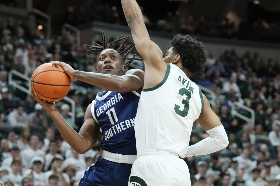 Georgia Southern guard Jamar Franklin (11) attempts a layup as Michigan State guard Jaden Akins (3) defends during the first half of an NCAA college basketball game, Tuesday, Nov. 28, 2023, in East Lansing, Mich. (AP Photo/Carlos Osorio)