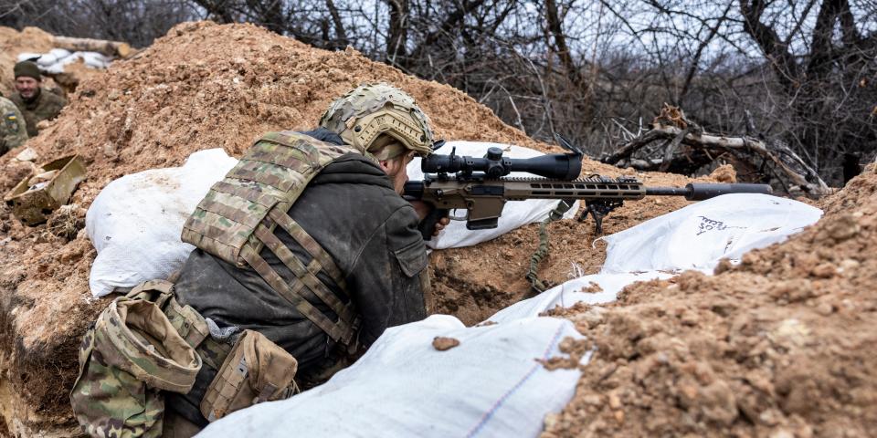 A Ukrainian sniper with the 28th Brigade looks towards a Russian position from a frontline trench on March 05, 2023 outside of Bakhmut, Ukraine.