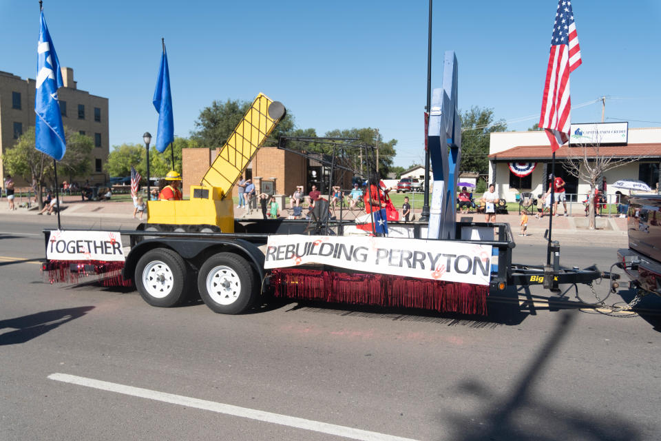 A float reminding the crowd that Perryton is rebuilding drives down Main Street at the 104th annual Wheatheart of the Nation Parade Saturday, Aug. 22 in Perryton.