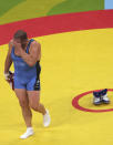 FILE - In this Aug. 25, 2004, file photo, Rulon Gardner, of United States, walks away after taking off his shoes to symbolize his retirement after defeating Sajad Barzi, of Iran, during men's GrecoRoman 120kg wrestling bronze medal bout at the 2004 Olympic Games in Athens, Greece. An Olympic Channel documentary debuting Wednesday, July 22, 2020, chronicles the highs and lows of Rulon Gardner in the 20 years since his stunning gold-medal victory in the 2000 Olympics. (AP Photo/David Guttenfelder, File)