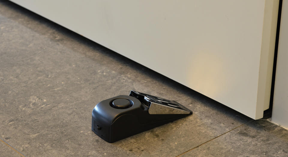 an alarm door stop placed behind a door