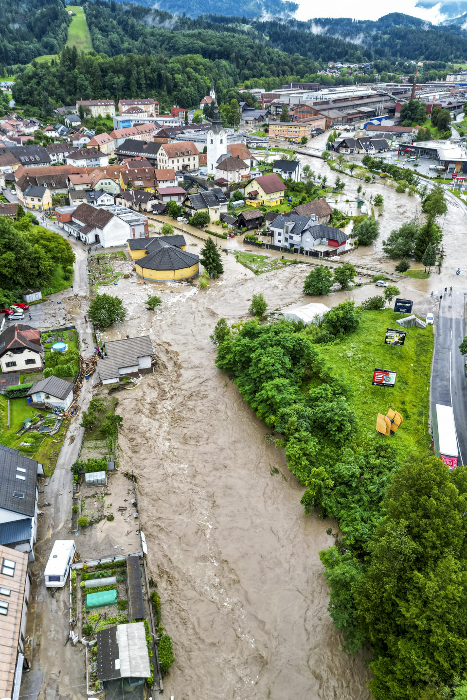 A flooded area is seen in Ravne na Koroskem, some 60 km (38 miles) northeast of Ljubljana, Slovenia, Friday, Aug. 4, 2023. Heavy rains caused flash floods and landslides in parts of Slovenia, blocking roads and bridges, flooding buildings and forcing evacuations on Friday. Slovenia's environmental agency, ARSO, raised the weather alert to the highest level after a month's amount of rain fell within 24 hours in northern, northwestern and central parts of the country. (AP Photo/Gregor Ravnjak)