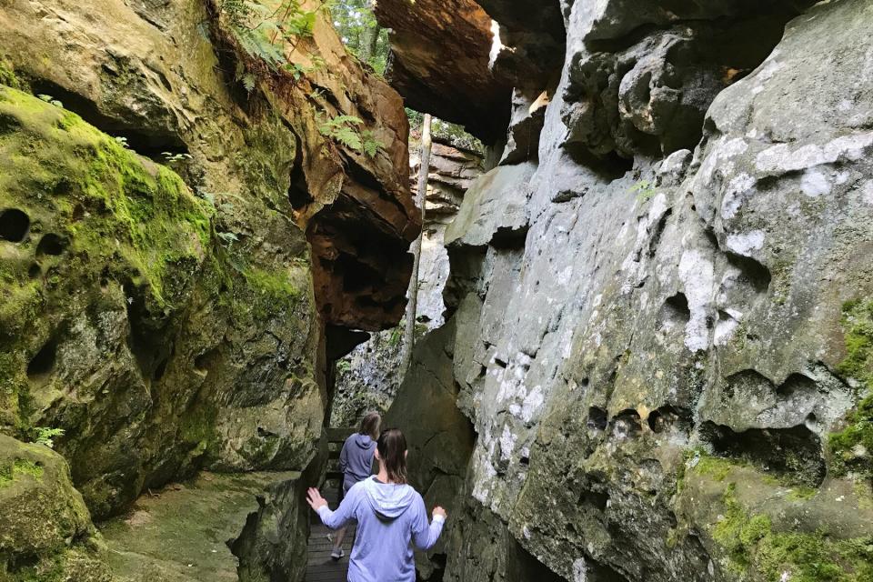 Cousins hiking and exploring rock formations in Beartown State Park in West Virginia.