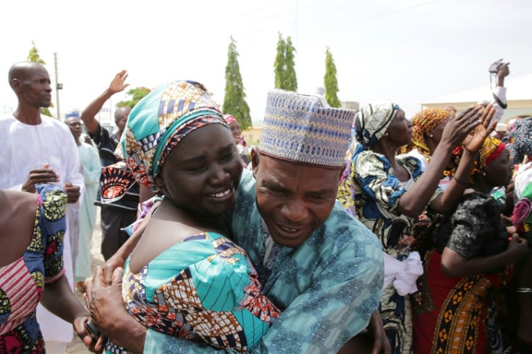 This handout picture released on May 20, 2017 by PGDBA & HND Mass Communication shows family members crying while being reunited with the released Chibok girls in Abuja on May 20, 2017