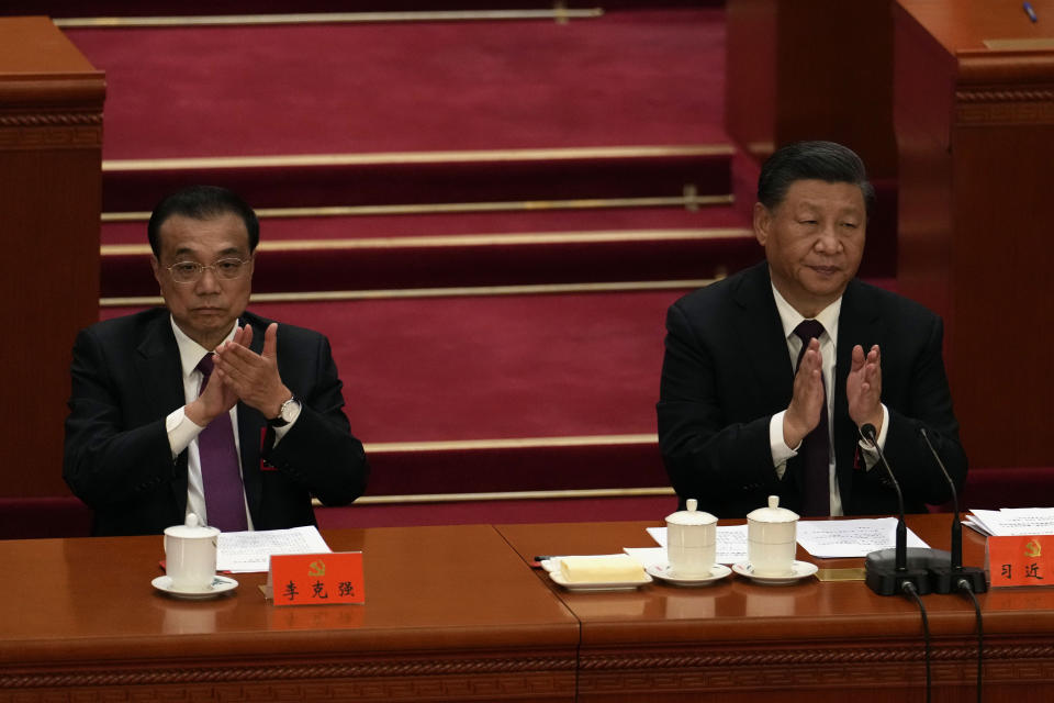 Chinese President Xi Jinping, right, and Premier Li Keqiang attend the closing ceremony of the 20th National Congress of China's ruling Communist Party at the Great Hall of the People in Beijing, Saturday, Oct. 22, 2022. (AP Photo/Ng Han Guan)