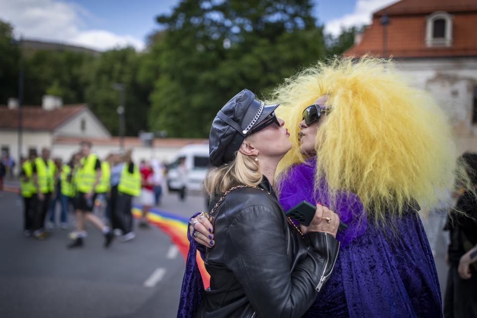 Girls kiss during the gay Pride parade in Vilnius, Lithuania, Saturday, June 8, 2024. (AP Photo/Mindaugas Kulbis)