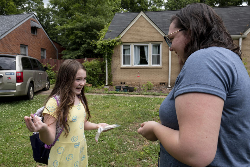 Abby Norman talks with her 9-year-old daughter Priscilla after she arrived home from school to the family's Decatur, Ga., home on Tuesday, May 18, 2021. Priscilla was in tears the first morning of testing because she felt pressure to do well, but didn't feel prepared after remote learning. (AP Photo/Ben Gray)