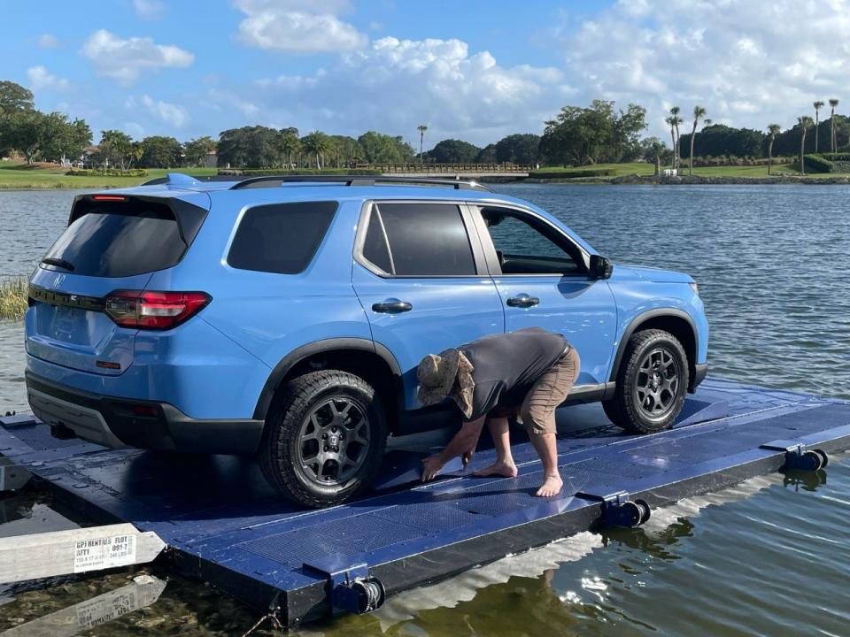 John Johnson secures the car to the float Thursday ahead of the 2023 Honda Classic at PGA National in Palm Beach Gardens. The tournament, the last under the Honda name, starts Feb. 23.
(Photo: Tom D'Angelo)