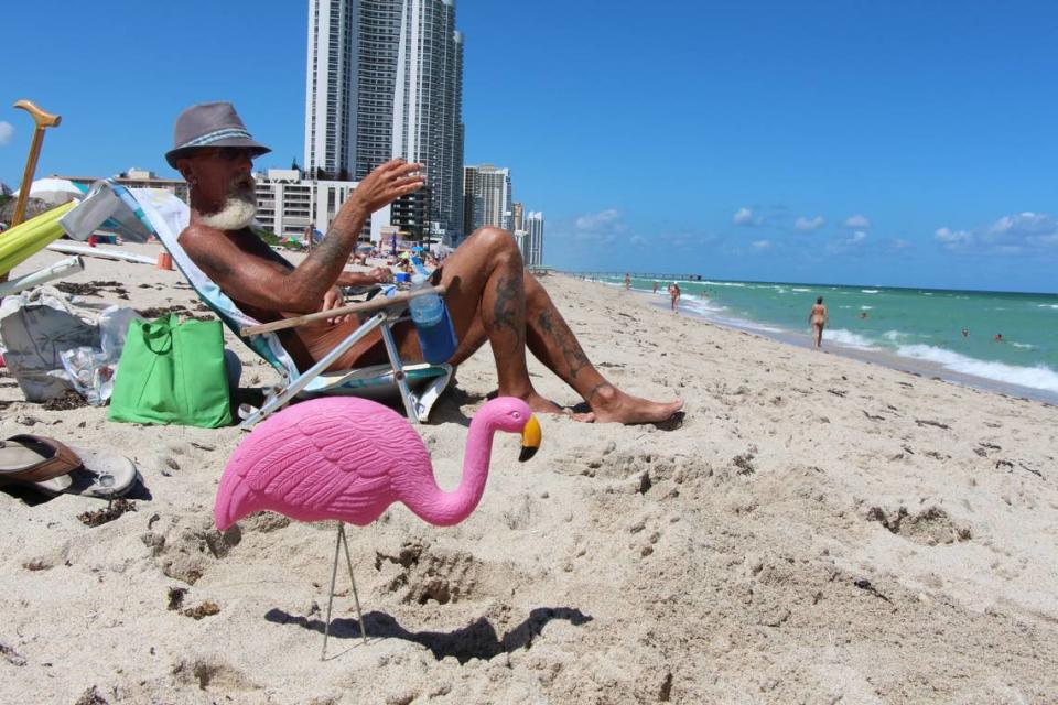 At Haulover, a nude sunbather has the company of a plastic flamingo. Miami Herald File