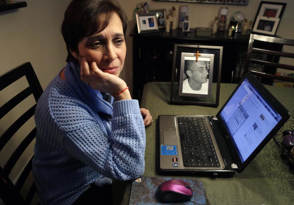 In this Monday, March 17, 2014 photo, Patty DiRenzo pauses as she uses a computer at her home in Blackwood, N.J., to look online for people seeking help for drug addiction. Her son, Salvatore Marchese, was found dead of a heroin overdose in her car, a needle and a bag of heroin on the center console. (AP Photo/Mel Evans)