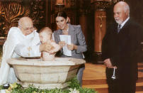 <p>Canadian singer Celine Dion (2nd R) and her husband Rene Angelil (R) watch the baptism ceremony for their son Rene-Charles being performed by Bishop Michel Sayde (L) at Notre Dame Basilica in Montreal, July 25, 2001. Dion, 33, is currently on a three-year sabbatical from show business as she takes care of her infant son, born six months ago. The singer was recently named the world's best-selling female artist selling more than 125 million albums worldwide.</p> 