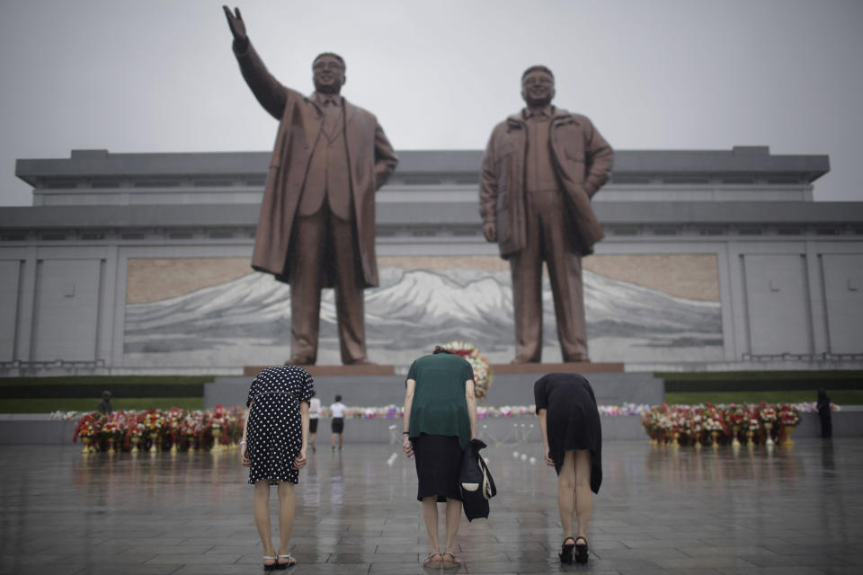 FILE - North Korean women bow to pay their respects to their late leaders Kim Il Sung and Kim Jong Il at Munsu Hill on Thursday, July 27, 2017, in Pyongyang, North Korea as part of celebrations for the 64th anniversary of the armistice that ended the Korean War. With a U.S. soldier crossing the border into North Korea at the border town of Panmunjom on Tuesday, July 18, 2023, and in custody, talk turns to the nation itself — a country that is known for its suspicion of outsiders but also rejects frequent descriptions of it as reclusive. (AP Photo/Wong Maye-E, File)