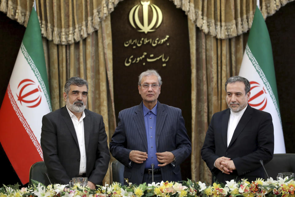 From left to right, spokesman for Iran's atomic agency Behrouz Kamalvandi, Iran's government spokesman Ali Rabiei and Iranian Deputy Foreign Minister Abbas Araghchi, attend a press briefing in Tehran, Iran, Sunday, July 7, 2019. The deputy foreign minister says that his nation considers the 2015 nuclear deal with world powers to be a "valid document" and seeks its continuation. (AP Photo/Ebrahim Noroozi)