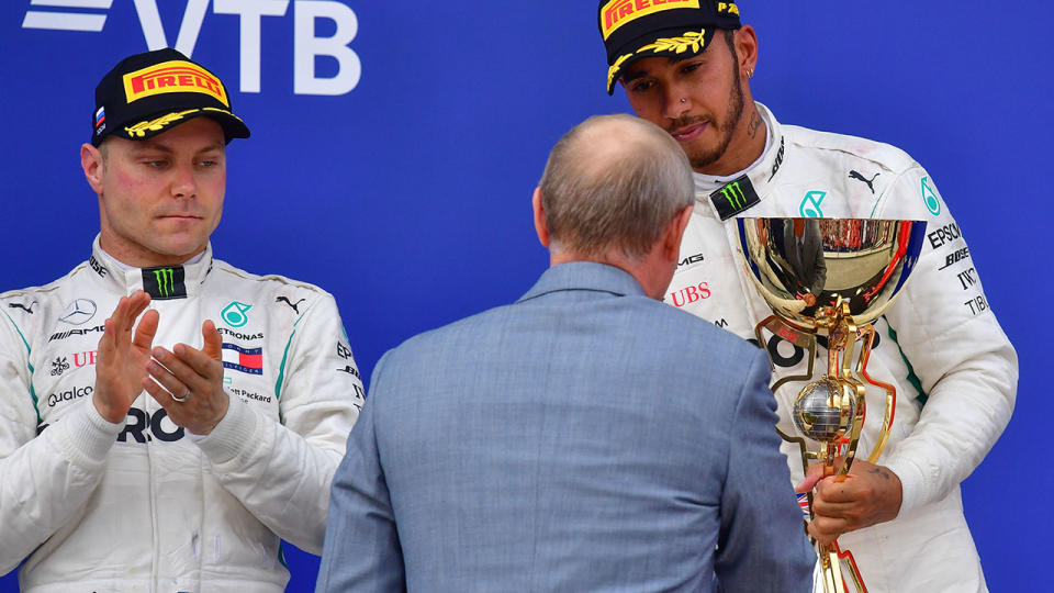 Valtteri Bottas and Lewis Hamilton during the podium ceremony. (Photo by Andrej ISAKOVIC / AFP)