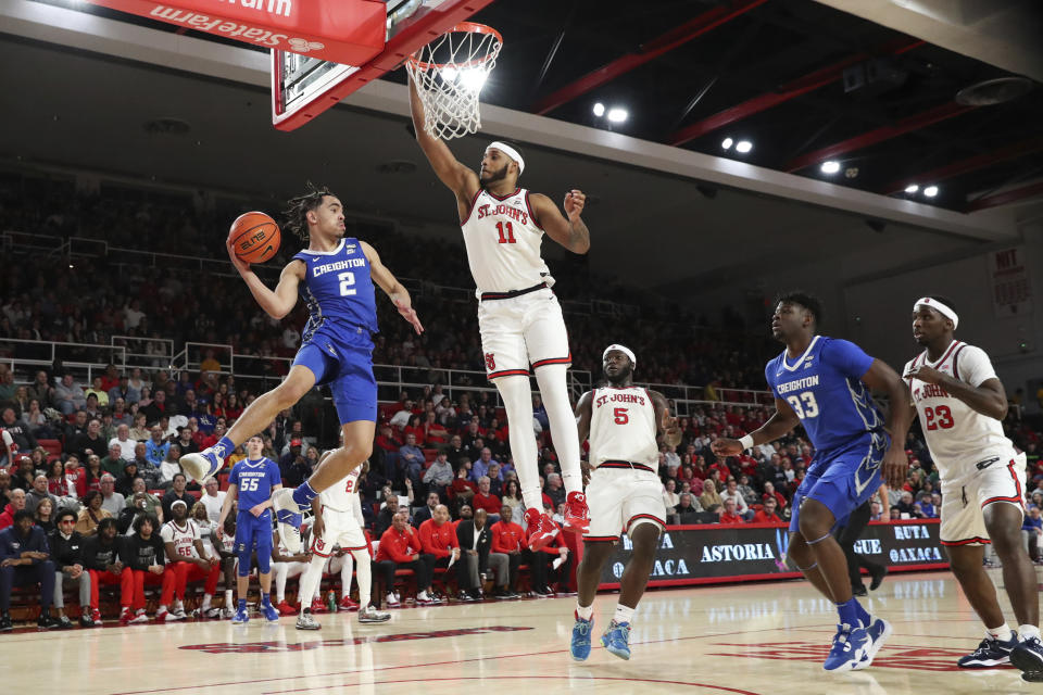 Creighton guard Ryan Nembhard (2) looks to pass the ball against St. John's center Joel Soriano (11) as guard Dylan Addae-Wusu (5), Creighton center Fredrick King (33), and St. John's forward David Jones (23) watch during the first half of an NCAA college basketball game Saturday, Feb. 18, 2023, in New York. (AP Photo/Jessie Alcheh)