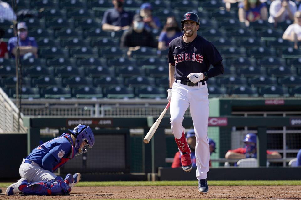 Cleveland Indians' Bradley Zimmer, right, hops on one foot after being hit by a pitch as Chicago Cubs catcher P.J. Higgins, left, controls the ball during the fifth inning of a spring training baseball game Thursday, March 18, 2021, in Goodyear, Ariz. (AP Photo/Ross D. Franklin)