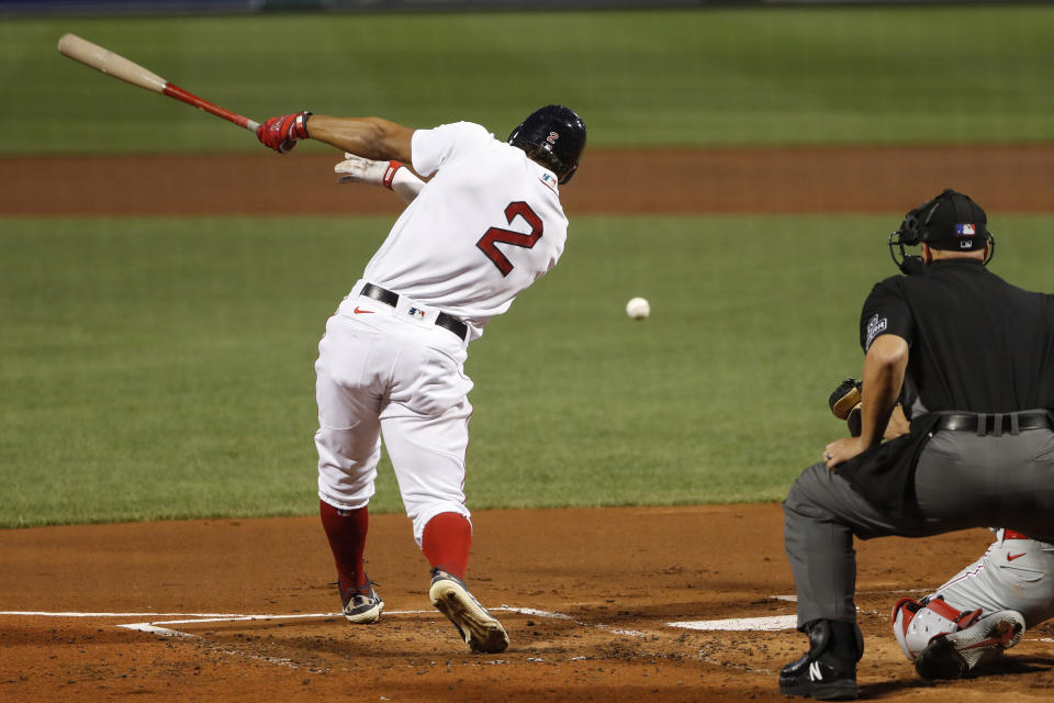 Boston Red Sox's Xander Bogaerts hits an RBI single against the Philadelphia Phillies during the first inning of a baseball game Tuesday, Aug. 18, 2020, at Fenway Park in Boston. (AP Photo/Winslow Townson)