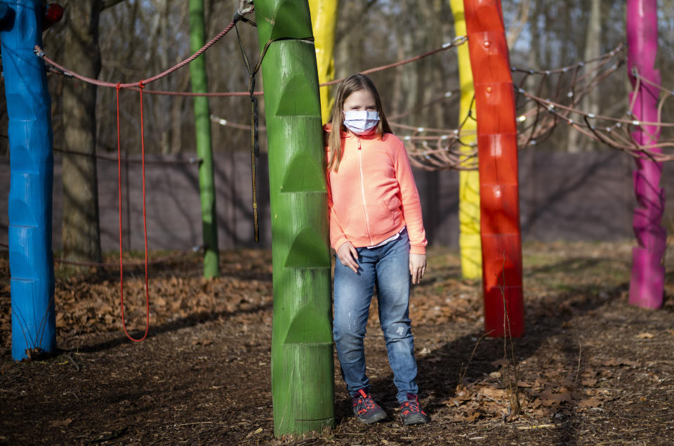 Nine-year-old girl Pollina Dinner poses for a photo at the Arche, or Ark, an organization that supports children, youth and families, in the Hellersdorf neighbourhood, on the eastern outskirts of Berlin, Germany, Tuesday, Feb. 23, 2021. After two months of lockdown, Pollina Dinner went back to school for the first time on Monday, Feb. 22. Since the outbreak of the coronavirus pandemic, the Arche has had to reduce their real face-to-face assistance or traditional classroom schooling as an offer for children, mainly from underprivileged families, drastically. Some kids are still allowed to come over in person, but only once every two weeks. (AP Photo/Markus Schreiber)