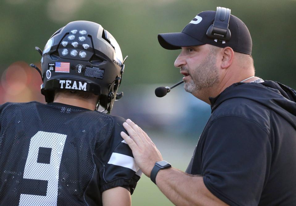 Perry head coach Zach Slates instructs quarterback Austin Mattox during a home game vs. Jackson in 2022.