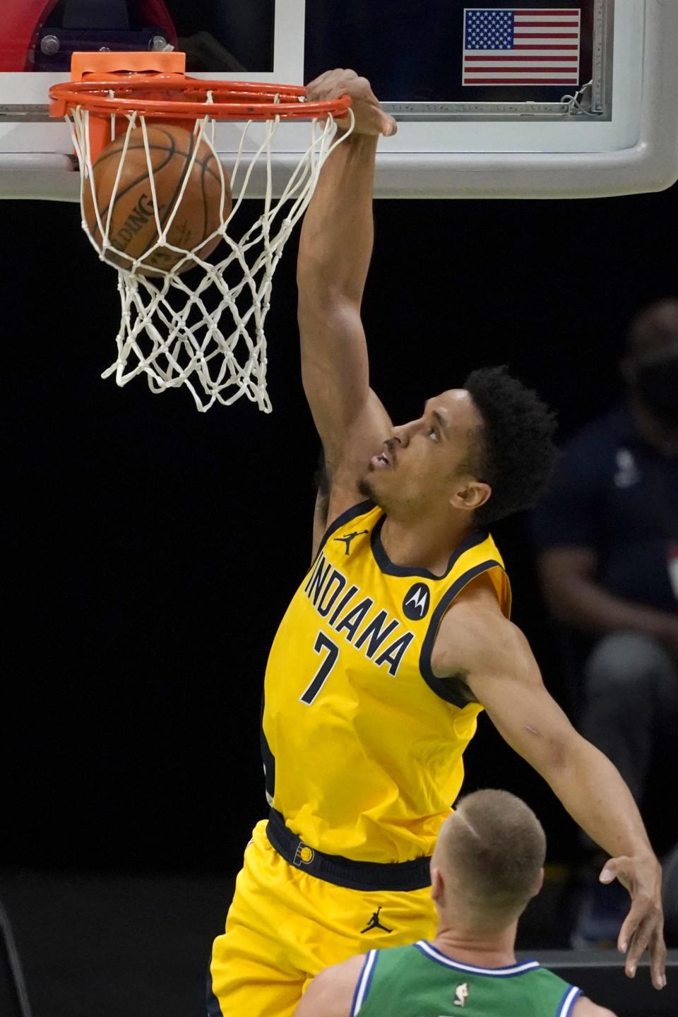 Indiana Pacers guard Malcolm Brogdon dunks during the first half of the team's NBA basketball game against the Dallas Mavericks in Dallas, Friday, March 26, 2021. (AP Photo/Tony Gutierrez)