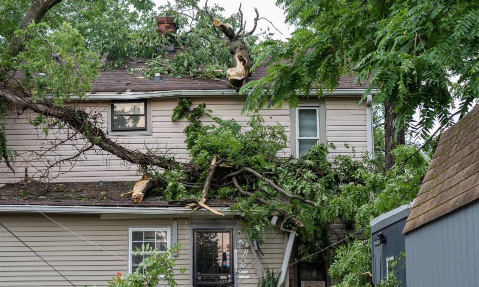 Houses were damaged by fallen trees after an EF1 tornado blew through 28th St. near Woodland Avenue in Louisville’s West End on Thursday, July 4, 2024.