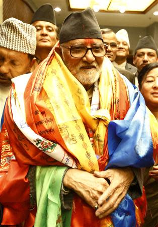 Newly elected Nepalese Prime Minister Sushil Koirala smiles as he walks out from the Parliament after being elected as the Prime Minister in Kathmandu February 10, 2014. REUTERS/Navesh Chitrakar