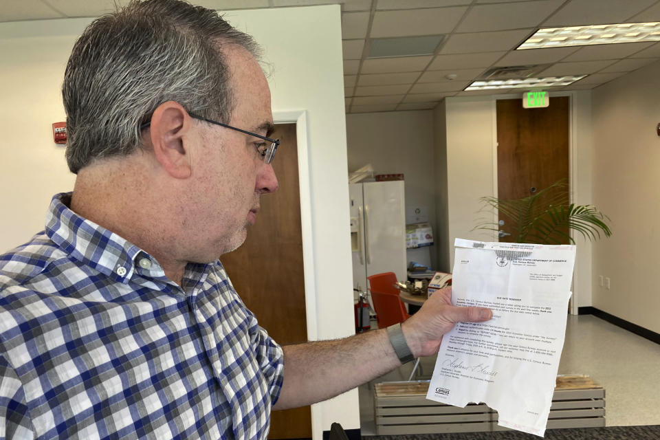 Erik Paul reads a notice from the U.S. Census Bureau reminding his software development firm to complete the 2022 Economic Census in Orlando, Fla. on Friday, March 24, 2023. Paul was wary of answering some of the personal financial questions in the survey. It’s a problem federal agencies are facing as privacy concerns and online scams have caused response rates for their surveys to drop in recent years. (AP Photo/Mike Schneider)