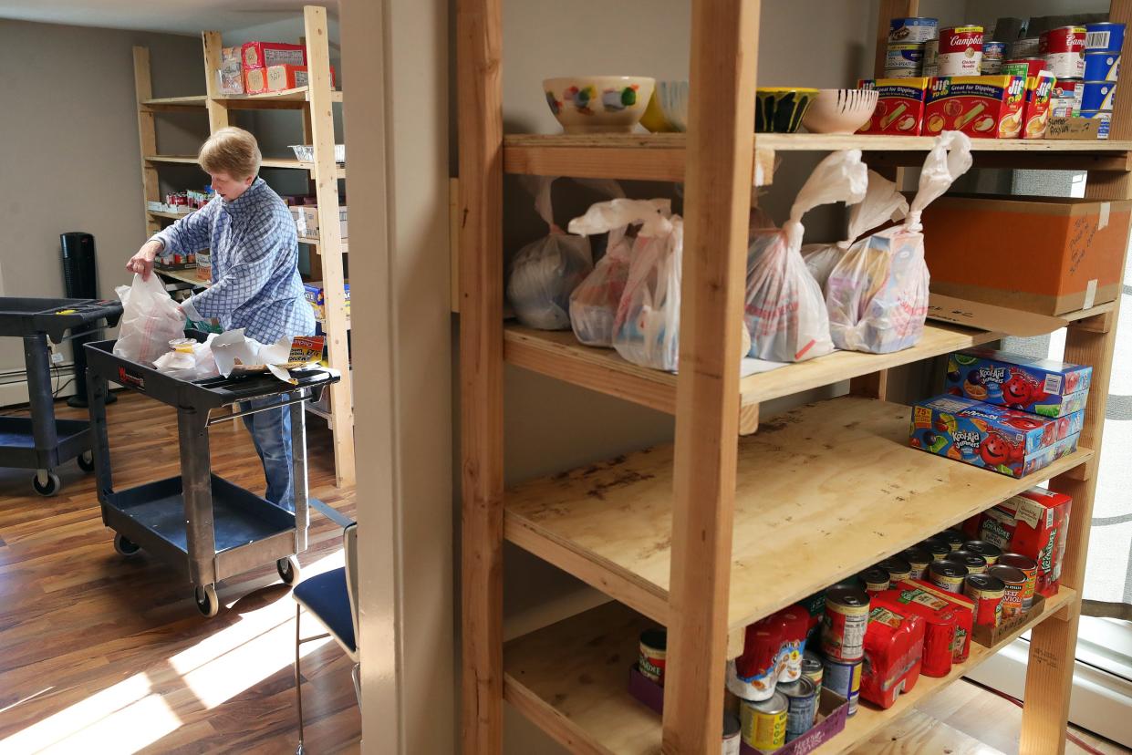 Carla Ringer, a volunteer at Copley Outreach Center, packs bags with weekend meal kits to be handed out to students in need in the Copley-Fairlawn school district.