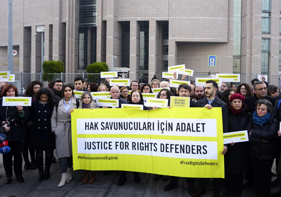 Turkish and international human rights activists face the media before the trial of the Amnesty International's former Turkey chairman and 10 other activists, in Istanbul, Wednesday, Feb. 19. 2020. A court in Istanbul will hand down verdicts for defendants in the closely-watched trial on charges of belonging to or aiding terror groups. The case against activists heightened concerns about Turkey's treatment of human rights defenders. (AP Photo)