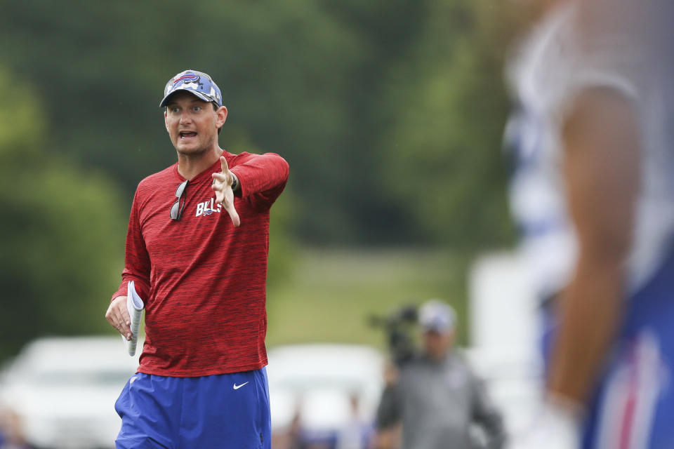 FILE - Buffalo Bills offensive coordinator Ken Dorsey speaks to the wide receivers during practice at the NFL football team's training camp in Pittsford, N.Y., on Aug. 4, 2022. Dorsey has the self-awareness to understand the gravity of the role of being a first-time coordinator and overseeing a high-powered Josh Allen-led Buffalo Bills offense . (AP Photo/Joshua Bessex, File)