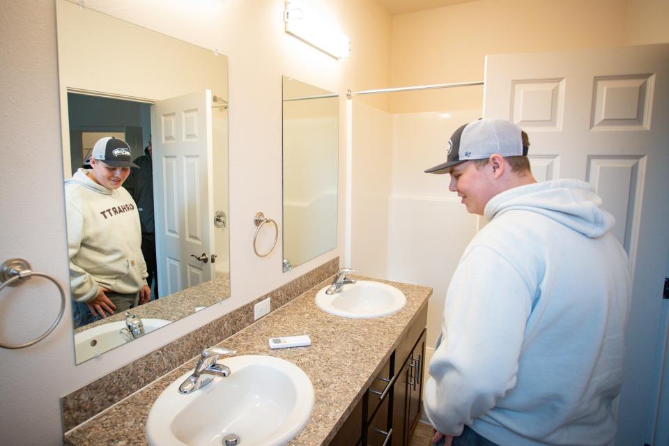Brayden O’Keeffe-Gotchall tours a home on Wednesday he and fellow classmates in the Eugene School District 4J Future Build program helped complete.