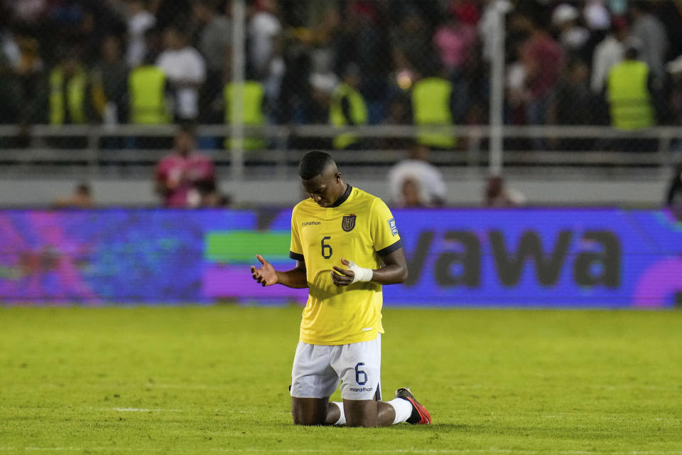 Ecuador's William Pacho kneels down in prayer on the pitch at the end of a FIFA World Cup 2026 qualifying soccer match against Venezuela, at the Monumental de Maturin Stadium in Maturin, Venezuela, Thursday, Nov. 16, 2023. (AP Photo/Ariana Cubillos)