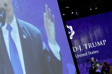 U.S. President Donald Trump appears on a large video screen as he delivers remarks at the APEC CEO Summit in Danang, Vietnam November 10, 2017. REUTERS/Jonathan Ernst