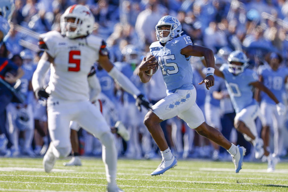 FILE - North Carolina quarterback Conner Harrell (15) breaks free for a touchdown run against Campbell duringg the second half of an NCAA college football game in Chapel Hill, N.C., Saturday, Nov. 4, 2023. North Carolina won 59-7. Harrell, who went 25-2 as a Thompson High School and was named the player of the year in Alabama as a senior, will be making his first career start against the Mountaineers (8-4). (AP Photo/Nell Redmond, File)