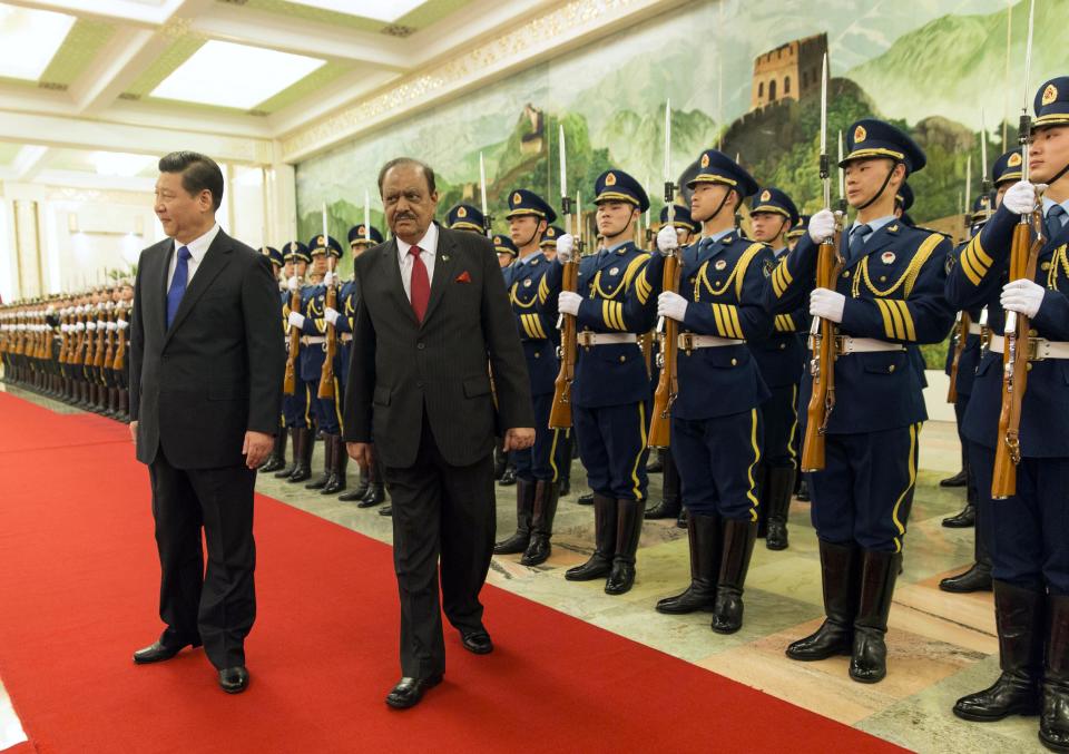 Pakistan's President Mamnoon Hussain, right, attends a welcoming ceremony with Chinese President Xi Jinping at the Great Hall of the People in Beijing, China, Wednesday, Feb. 19, 2014. Pakistani President Hussain is scheduled to meet Chinese leaders on a visit to Beijing focused on winning assistance for his country's ailing economy. (AP Photo/Adrian Bradshaw, Pool)