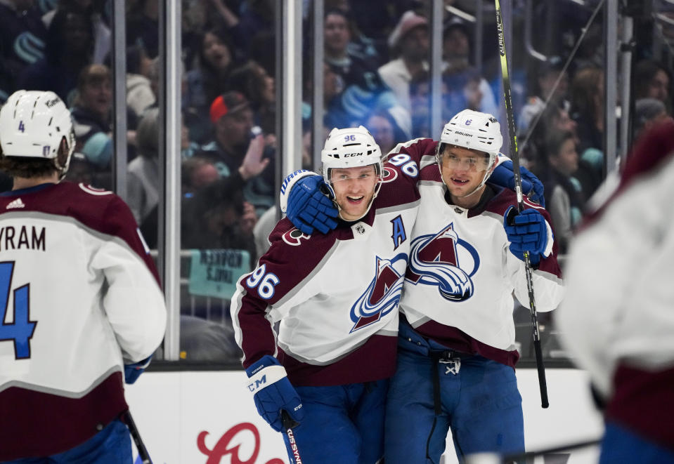 Colorado Avalanche defenseman Erik Johnson (6) celebrates his goal against the Seattle Kraken with Mikko Rantanen (96) and Bowen Byram (4) during the second period of Game 6 of an NHL hockey Stanley Cup first-round playoff series Friday, April 28, 2023, in Seattle. (AP Photo/Lindsey Wasson)