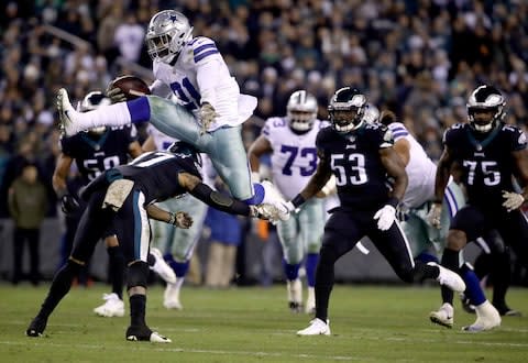 Dallas Cowboys running back Ezekiel Elliott (21) hurdles over Philadelphia Eagles defensive back Tre Sullivan (37) during the first half of an NFL football game - Credit: AP Photo/Matt Rourke