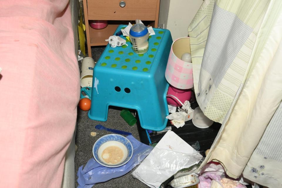 A mouldy baby’s bottle surrounded by litter in Finley’s bedroom (West Midlands Police)